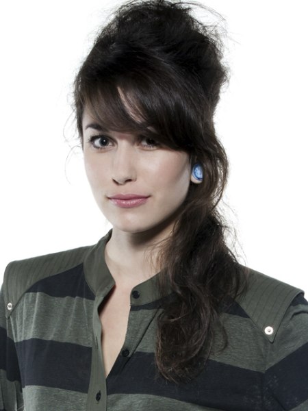 Hair in a semi-updo with a bun and long waves