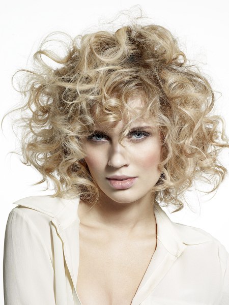 Medium length blonde hair with large curls