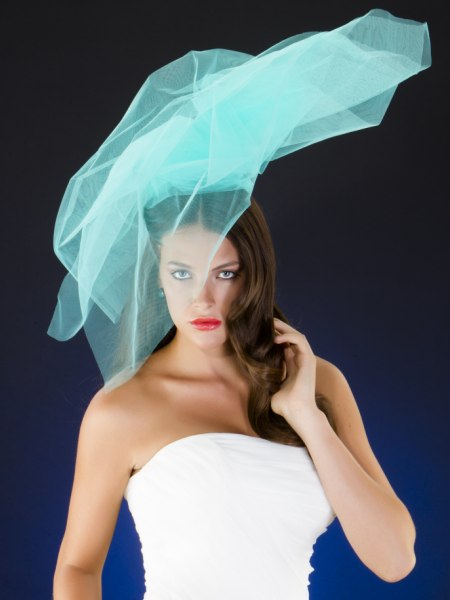 Brunette wedding hair and a teal colored veil