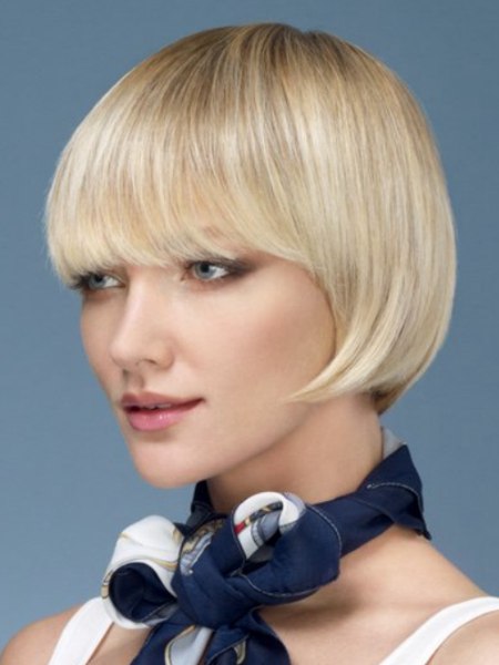 Short blonde bob with curved tips and a long fringe