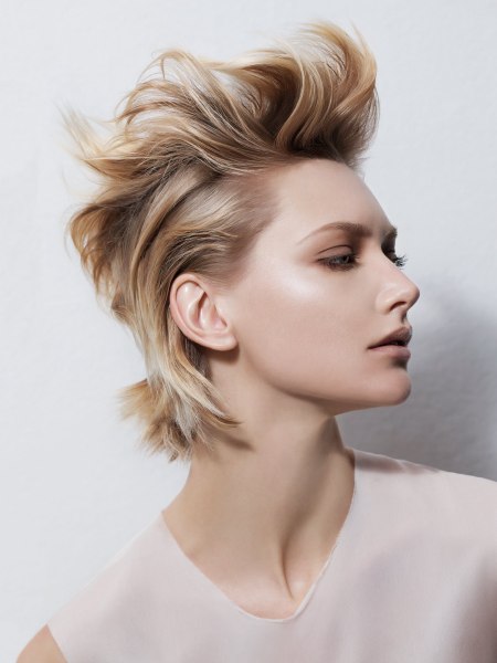 Trendy short blonde hair styled with the sides close to the scalp