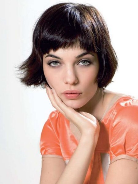 Brown bob haircut with a fringe and rounded corners