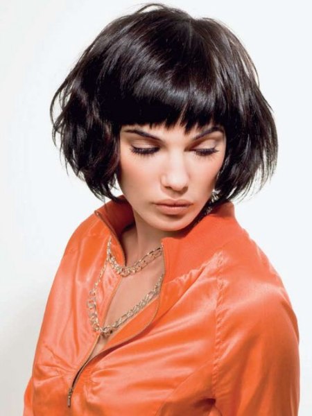 Brunette bob cut with bangs and wild styling