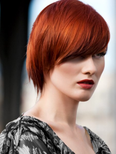 Red hair in a short cut with diagonal styling