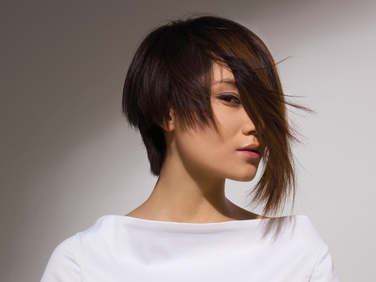 Asian hair model sporting a bob hairstyle with a long strand Asian hair model sporting a bob hairstyle with a long strand