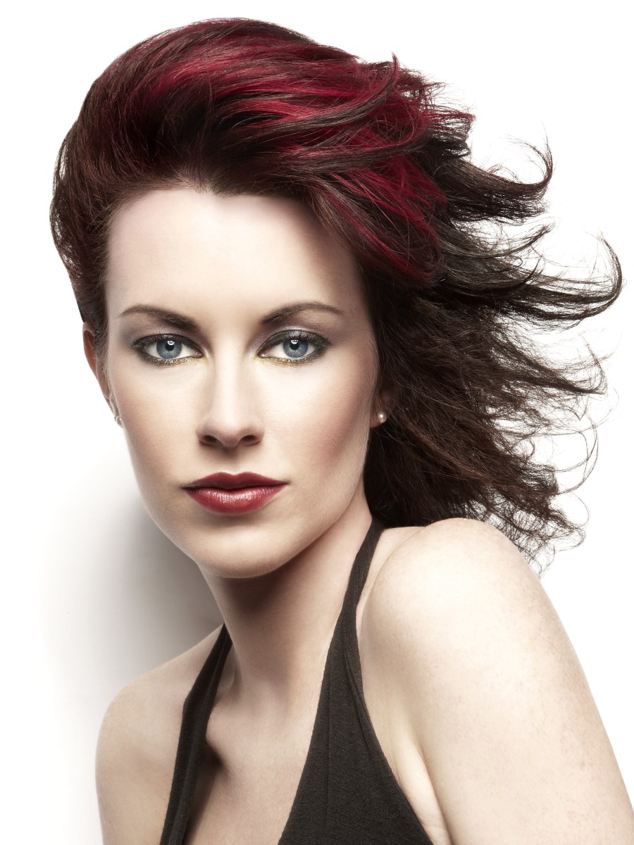 Elegant and windswept haircut for dark cherry red hair