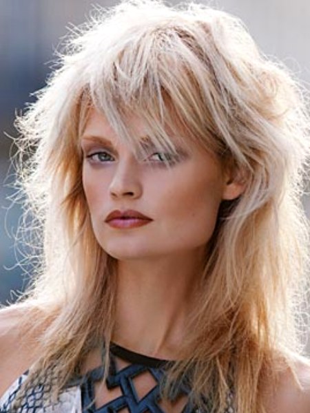 Layered and textured blonde hair below the shoulders