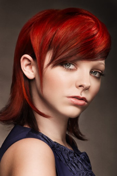 Bright ruby red hair cut in a refined and sophisticated shape