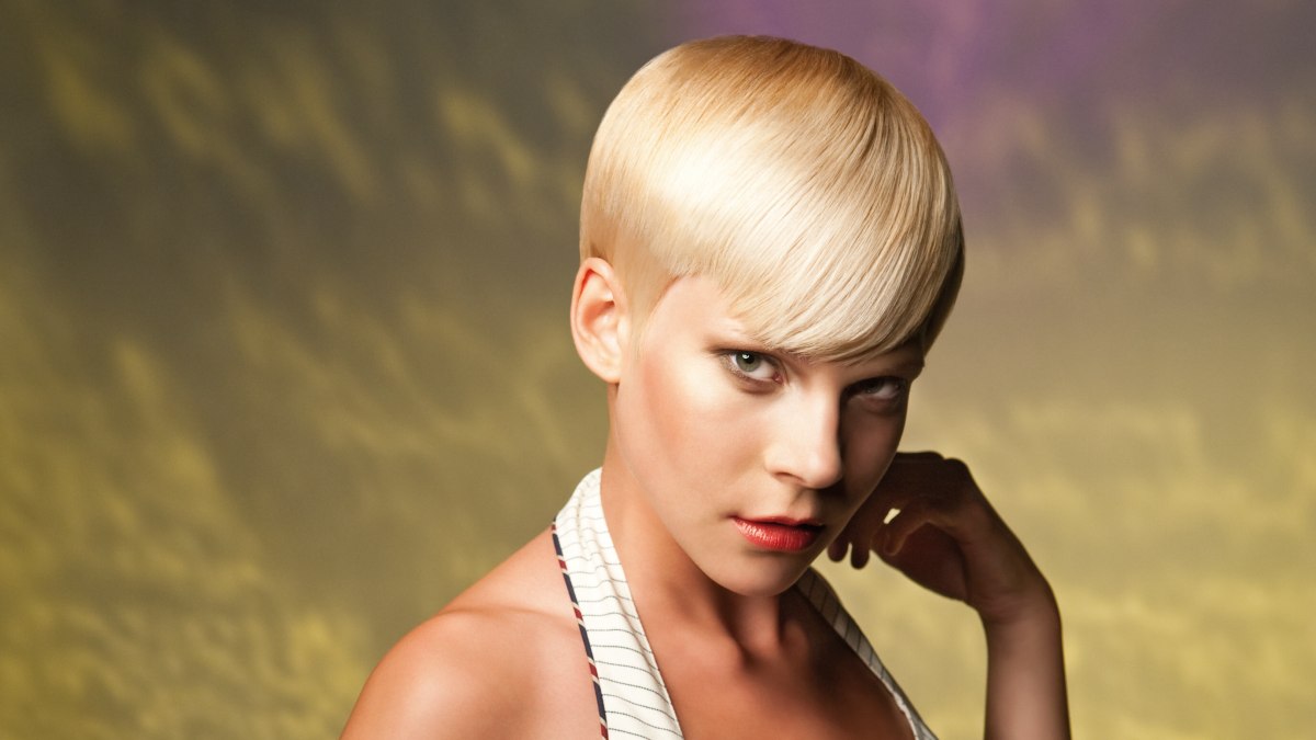 Short and sleek gamine cut with curved bangs for boyish charm