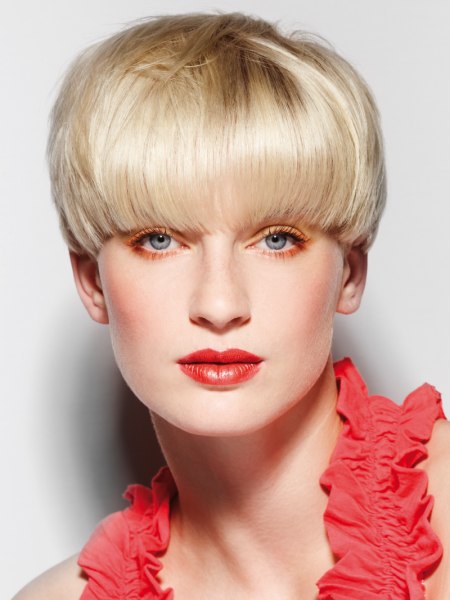 Blonde mushroom cut with the hair cut right above the eyes