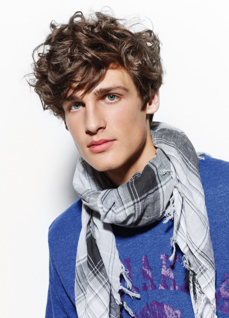 Preppy styling for a men's haircut with curls