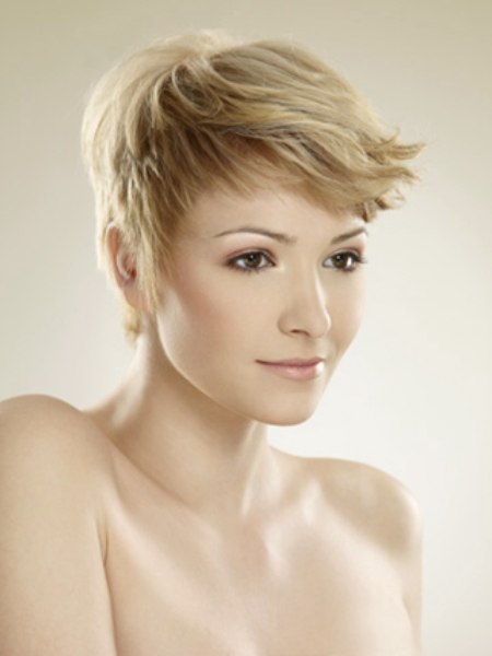 Blonde pixie cut with layers and curled bangs