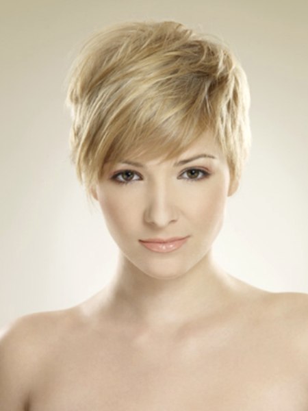 Blonde layered pixie cut with full bangs