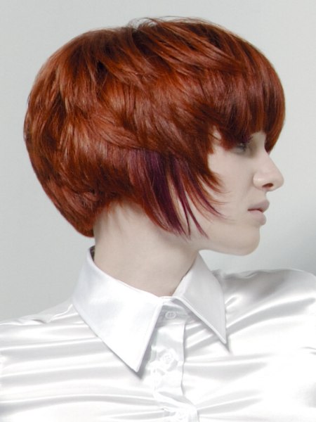 Short haircut with layers and roundness and a shiny silk blouse