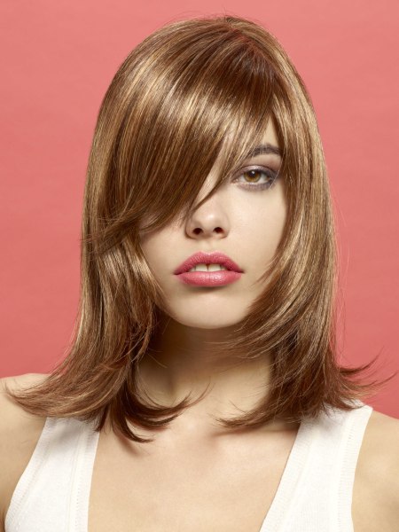 Shoulder-length tapered hairstyle with an outward flip