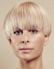 Blonde bowl cut with eyelash length hair