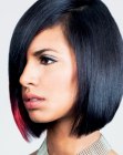 Black hair with a pink accent cut into a neck-length bob