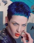 Very short clipper cut hair with a blue hue for women