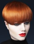 Coppery red hair cut into a short style with bangs