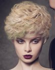 Short blonde hair with curls and a green shade