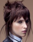 Short hairstyle with feathering tendrils along the sides