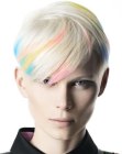 Very short platinum blonde hair with pastel color streaks