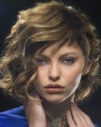 Contemporary hairstyle with one shorter side and wispy tips