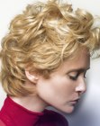 Short blonde hair with large curls and a smooth neck section