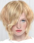Blonde angled bob with curls and movement