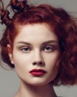 Spectacular hairstyle with a triangular shape and twirled red hair