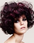 Dark purple hair with large curls and high volume