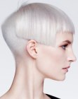 Very short platinum blonde hair with a shaved nape