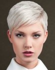 Blonde pixie cut with layering and side swept bangs