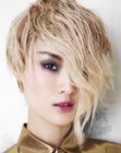 Blonde pixie cut with one longer side and movement