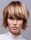 Short layered bob with thick long bangs and a play of hair colors