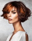 Short layered bob with wispy bangs and tendrils that frame the face