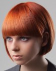 Short bob with structured bangs and an intense red hair color