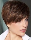 Feminine short pixie hairstyle with diagonal bangs