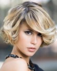 Short and bouncy above the jawline hairstyle with flicked ends for volume