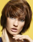 Short hairstyle with rounded contours, tapered ends and bounce