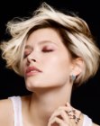 Short blonde hair with feathering to create height