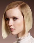 Sleek short blonde bob with a side part