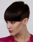 Very short hairstyle with a buzzed nape and sides for women