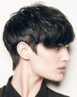 Dark brown hair cut in a pixie with longer top hair