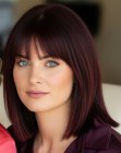 Shoulder-length dark red hair