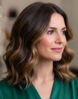 Shoulder-length brown haircut with waves and highlights