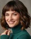 Wavy below the chin and shoulders bob with short bangs