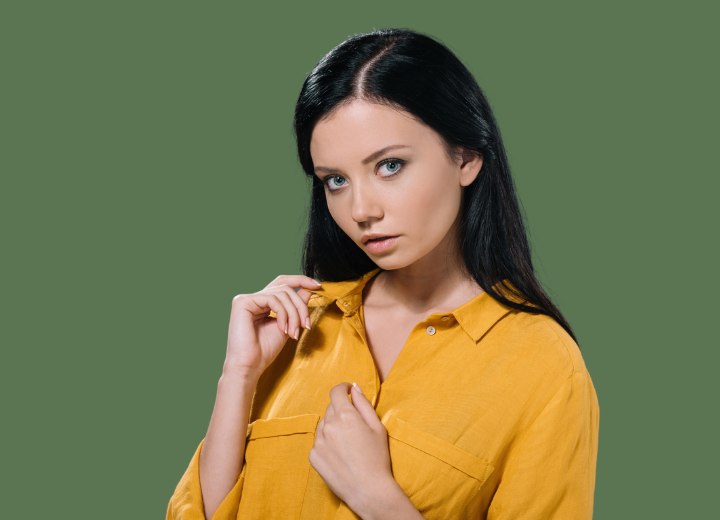 Brunette wearing a yellow buttoned blouse