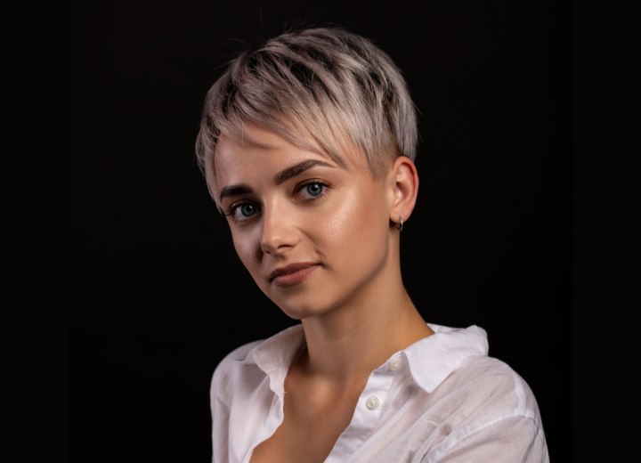 Attractive woman with sassy short hair, wearing a white buttoned shirt