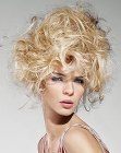 Blonde updo with piled curls and high volume